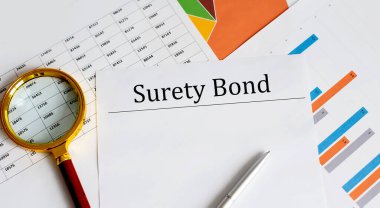 Masada Surety Bond kağıt kalem, grafik ve büyüteç ile