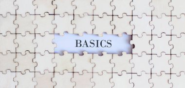 BASICS. İş konsepti. Beyaz arkaplanda farklı ifadelere sahip beyaz yapboz parçaları, üst görünüm