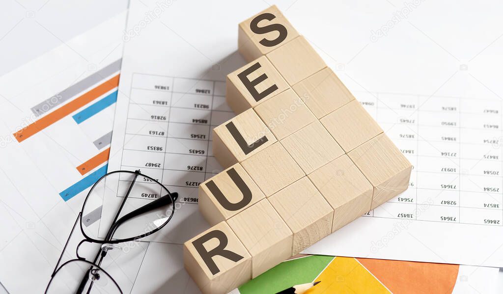 RULES words with wooden blocks on chart background. Business concept.