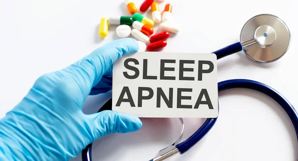 Card with text SLEEP APNEA supplies, pills and stethoscope. Medicine