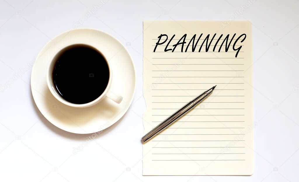PLANNING - white paper with pen and coffee on the white background