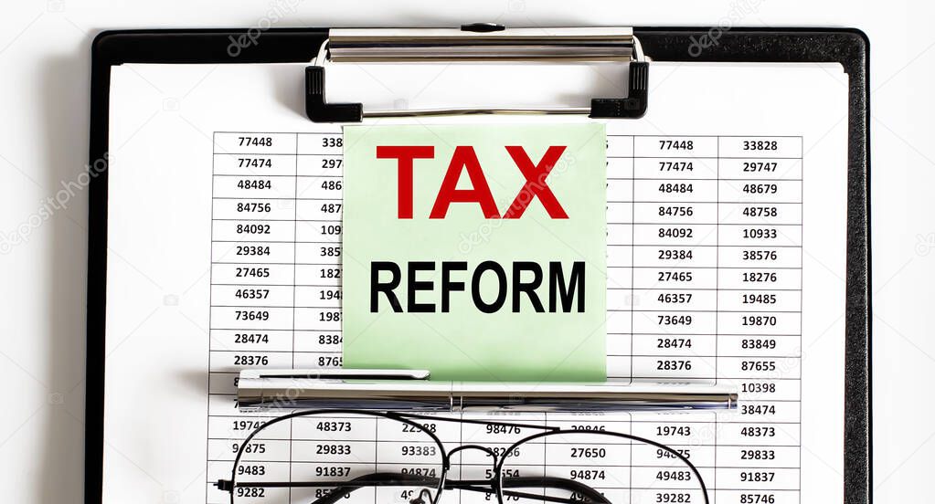 Closeup of the deadline time of tax with the tax reform and glasses