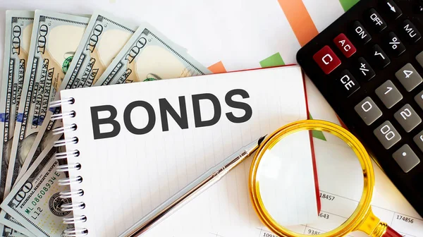 Woord Tekst Bonds Bedrijfsconcept Met Grafiek Dollars Kantoorgereedschappen — Stockfoto