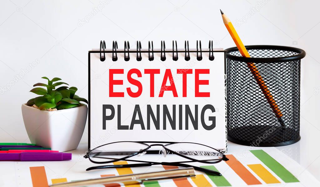 Estate Planning word with Notepad on the white background with markers ,charts and glasses