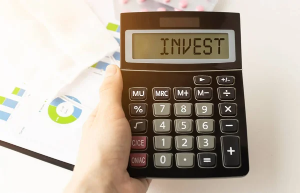 Une Calculatrice Avec Inscription Invest Est Placée Dans Pile Documents — Photo