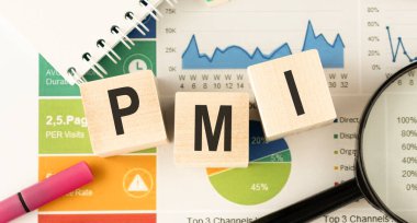 Ahşap küp ve altın kalem üzerine PMI metni mum döküman kağıdı, ekonomik veri kavramı üzerinde yatıyordu.