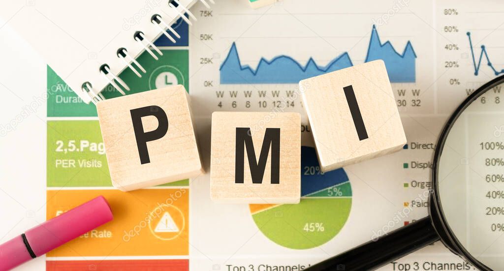 Text PMI on wood cube and gold pen lay on chart candle document paper , economic data concept.
