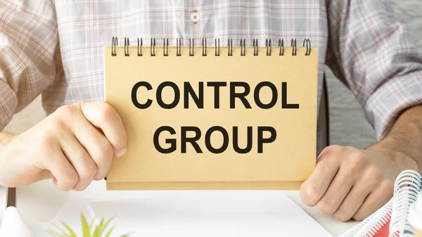 Self-control concept. Text Control Group written on a card against the background in hands businessman