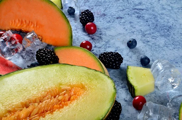 Fresh Cut Melon Watermelon Berries Ice Cubes Blue Stone Background — Stock Photo, Image