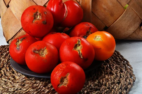 Rotten many red tomato. Tomatoes damaged by pest. Mold on vegetables.