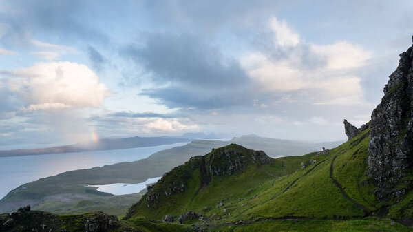 Rainbow by the Old Man of Storr at the Isle of Skye. Hiking in the Quairing Mountains on the Isle of Skye in Scotland