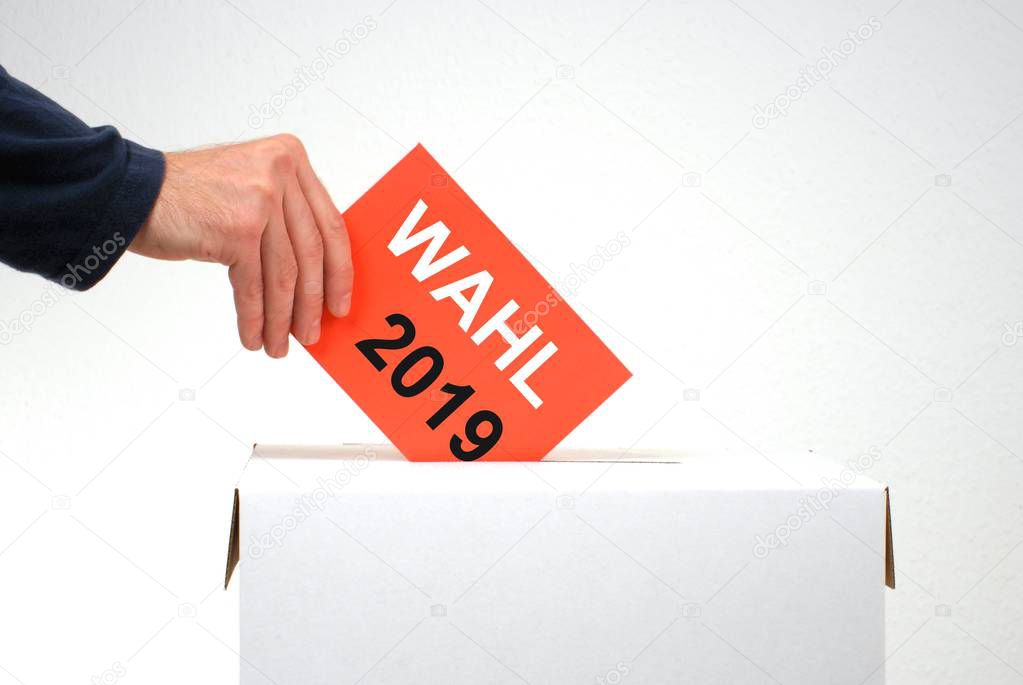 Hand with red envelope and ballot box showing election 2019 in german language