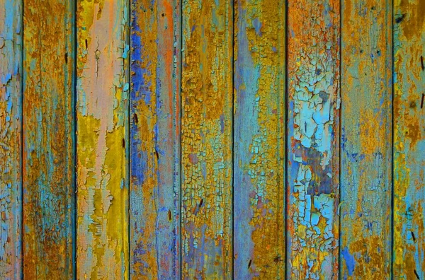 Parede de madeira colorida com cores desgastadas laranja, amarelo e azul — Fotografia de Stock