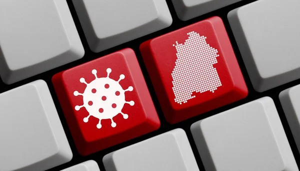 コロナウイルスのアイコンとドイツ連邦国家バーデン ヴュルテンベルク州のシルエットを持つコンピュータキーボード — ストック写真