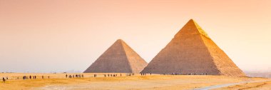 The pyramids at Giza in Egypt. Web banner in panoramic view. Africa. clipart