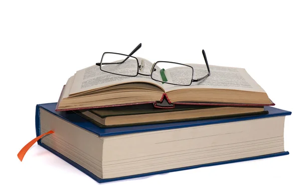 Reading glasses lie on a stack of books and books in expanded form with blurred text — Stock Image Reading Glasses Lie Stack Books Books Expanded Form Blurred Text Stock Image