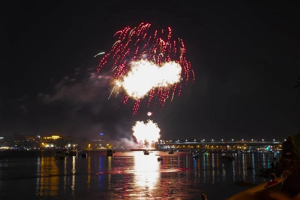 Beautiful salute of yellow fireballs and red spray in the form of beads on the day of the city in Kostroma