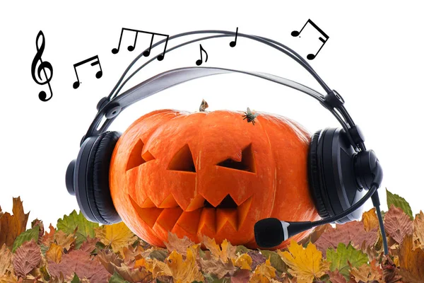 Orange pumpkin in headphones with glowing eyes celebrating Hallo — стокове фото
