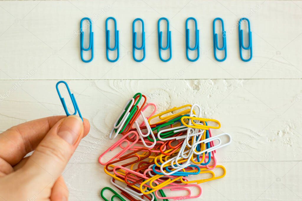 colorful paper clips on white background, office life, perfectionism, psychological training