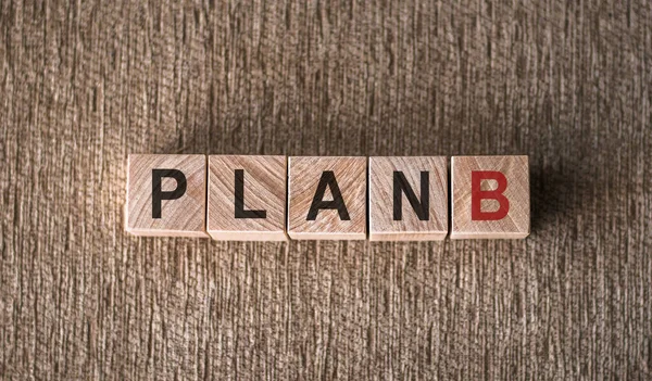 stock image Plan B text on wooden cubes on a brown background