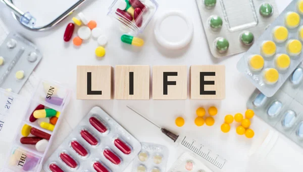 Life Word Wooden Blocks Desk Medical Concept Pills Vitamins Stethoscope — Stock Photo, Image