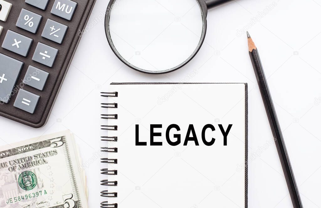 Legacy text, inscription, phrase is written in a notebook that lies on a white table. Business concept.