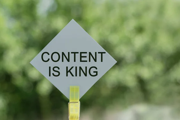 Content is King - text on card with green blur background