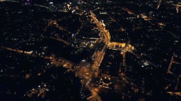 Aerial view from Drone: Night city flying over the road and night lights.