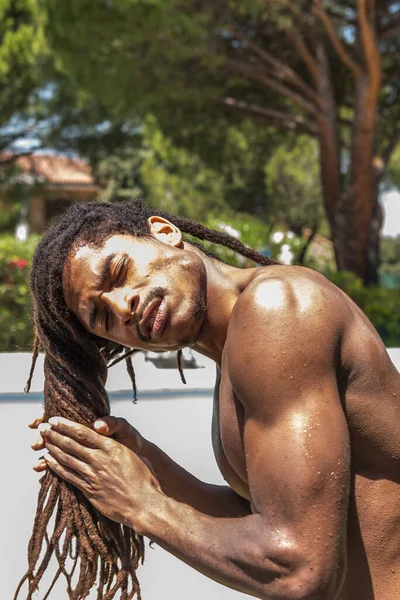 Young muscular black man with long dreadlocks