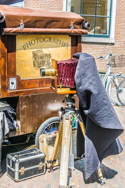 Amsterdam, Hollanda - 19 Temmuz 2018: Sokak fotoğrafçısı eski analog kamera kullanarak turistlerin fotoğraflarını çekiyor