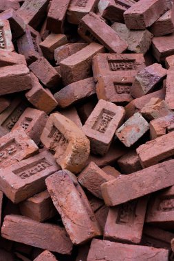 Hint alfabesiyle yazılmış kırmızı tuğlalar. Hindistan 'da inşaat malzemeleri