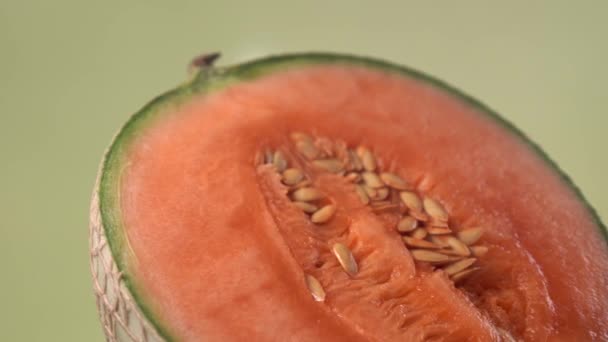 Cantaloupe Orange Melon on Green Background. Creative rotating macro shot of fresh and healthy fruit — Stock Video