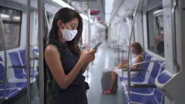 Metro Treni metrosuyla seyahat eden maskeli genç bir kadın. Coronavirus salgını zamanında kadın banliyö çalışanı.