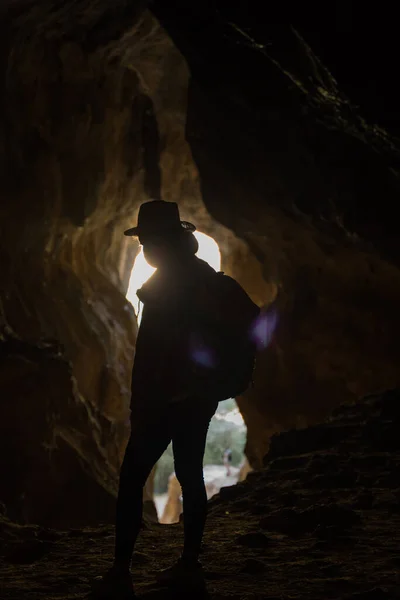 Female Explorer is Visiting a Neolithic Cave