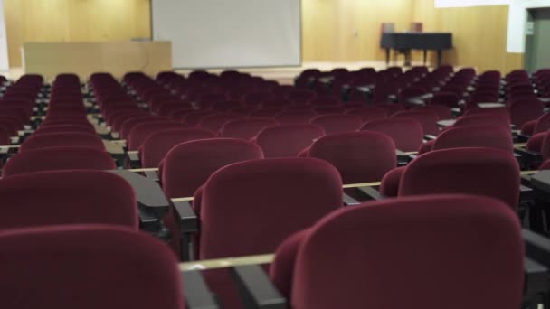Leerer Saal in Zeiten der Coronavirus-Pandemie. Großer Konferenzsaal mit roten Samtstühlen — Stockvideo