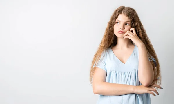 Фото Pensive European Young Woman Curly Long Hair Looking Having — стоковое фото