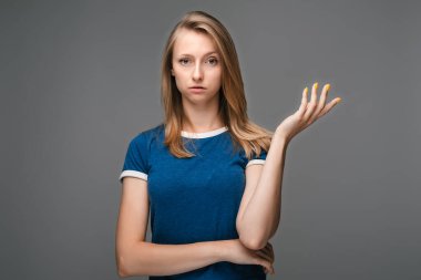 What the hell are you talking about, nonsense. Studio shot of frustrated female with blonde straight hair gesturing with raised palm, frowning, being displeased and confused with dumb question clipart