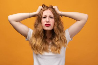 Oh hayır. Sinirli genç bir kadın, dalgalı kızıl saçlı, ellerini başının üstünde tutuyor, saçlarına dokunuyor, gürültüden muzdarip, mutsuz bir kadın acı çekiyor. Sorunlar, şaşkınlık, korku, fobi konsepti.