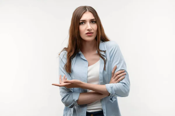Sorun ne? Uzun kestane rengi saçları olan, günlük giysiler giymiş, omuz silkmiş, kafaları karışmış, sorularla karışmış, seçimini yaparken şüpheyi hisseden bir kızın stüdyo fotoğrafı. İnsan duyguları kavramı