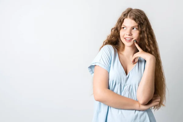 Фото Pensive European Young Woman Curly Long Hair Looking Having — стоковое фото