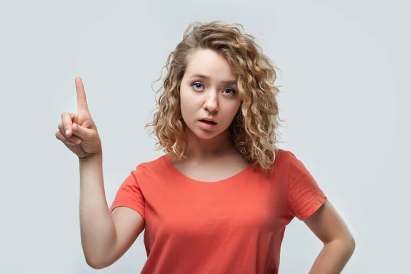 Portrait Serious Blonde Girl Curly Hair Casual Shirt Showing Index — Stock Photo, Image