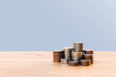 Coins stack or money stack and row of coin on wooden table. Financial, Business growth concept. Investment and saving concept
