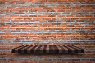 Empty wooden shelf on old brick wall texture. For display or montage your products with focus wooden shelf top in the foreground. Empty wooden brown shelf. shelves