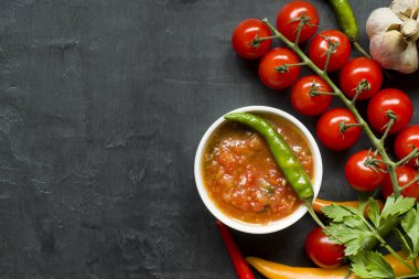 Sıcak biber çok renkli, şube, sarımsak ve diğer baharatlar siyah arka plan kopya alanı üzerine kiraz domates.