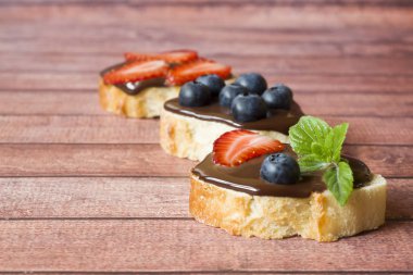 Çikolatalı hamur ve çilek yaban mersini nane masada ekmek tost. Kopya alanı