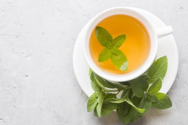 Çay taze nane ile gri beton zemin üzerine bırakır. Kopya alanı