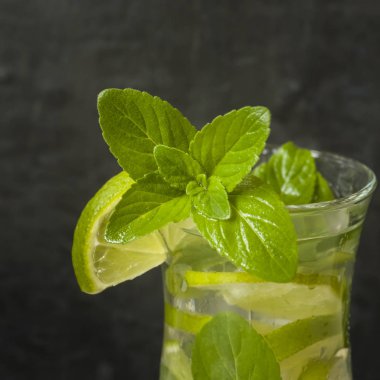 Serinletici içecekler limonata yaz ya da kireç taze nane yaban mersini buzla kokteyl Mojito. Karanlık duvar.