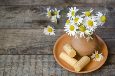 Natürmort papatyalar bir vazo ve gözleme tüpler bir buket. Ahşap rustik tarzı