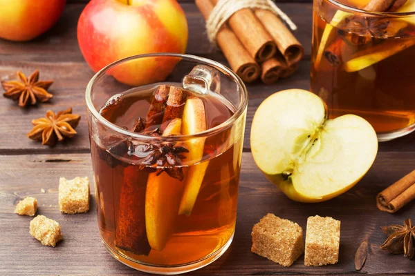 Mulled wine cider in glass mugs with cinnamon, anise and apples. The concept of the cocktail bar