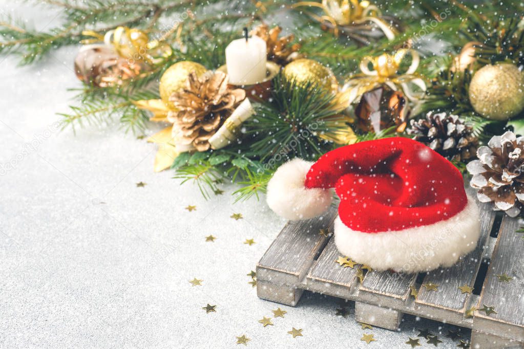 Santa Claus hat on the background of Christmas trees. Christmas decorations. New year concept.